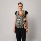 Woman carrying newborn in NAEVII Limitless Baby Carrier, black and white Houndstooth, front carry#Color_Houndstooth