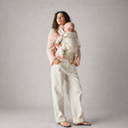 Woman carrying baby in NAEVII Limitless Baby Carrier, Neutral Houndstooth#Color_Neutral Houndstooth