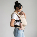Woman carrying newborn in NAEVII Soft Baby Carrier, beige Cream, front carry#Color_Cream