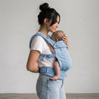 Woman carrying newborn in NAEVII Soft Baby Carrier, light blue Denim, front carry#Color_Denim