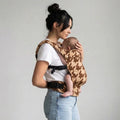 Woman carrying newborn in NAEVII Soft Baby Carrier, brown Mocha Houndstooth, front carry#Color_Mocha Houndstooth